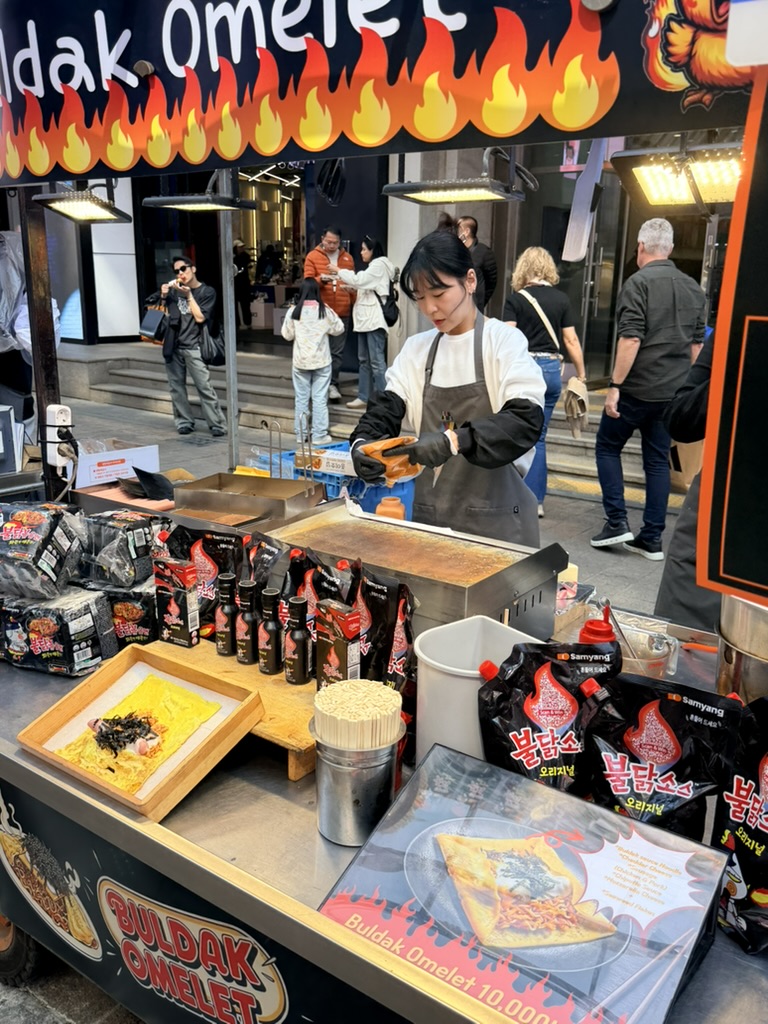 Street food stall in Myeongdong with skewers and tteokbokki 17