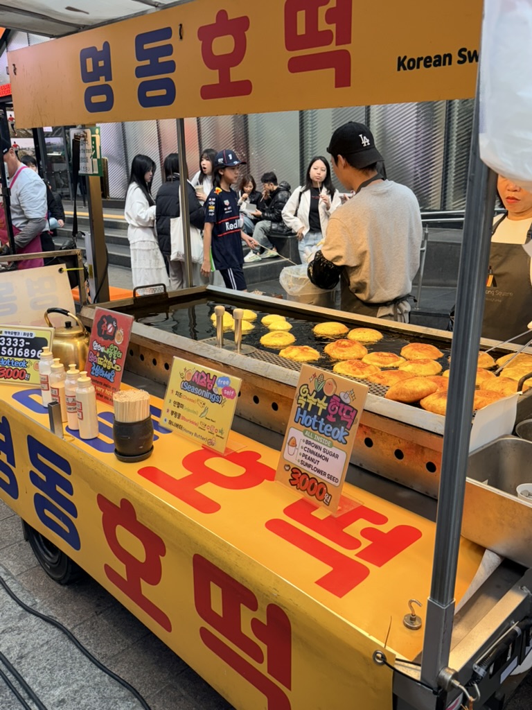 Street food stall in Myeongdong with skewers and tteokbokki 2