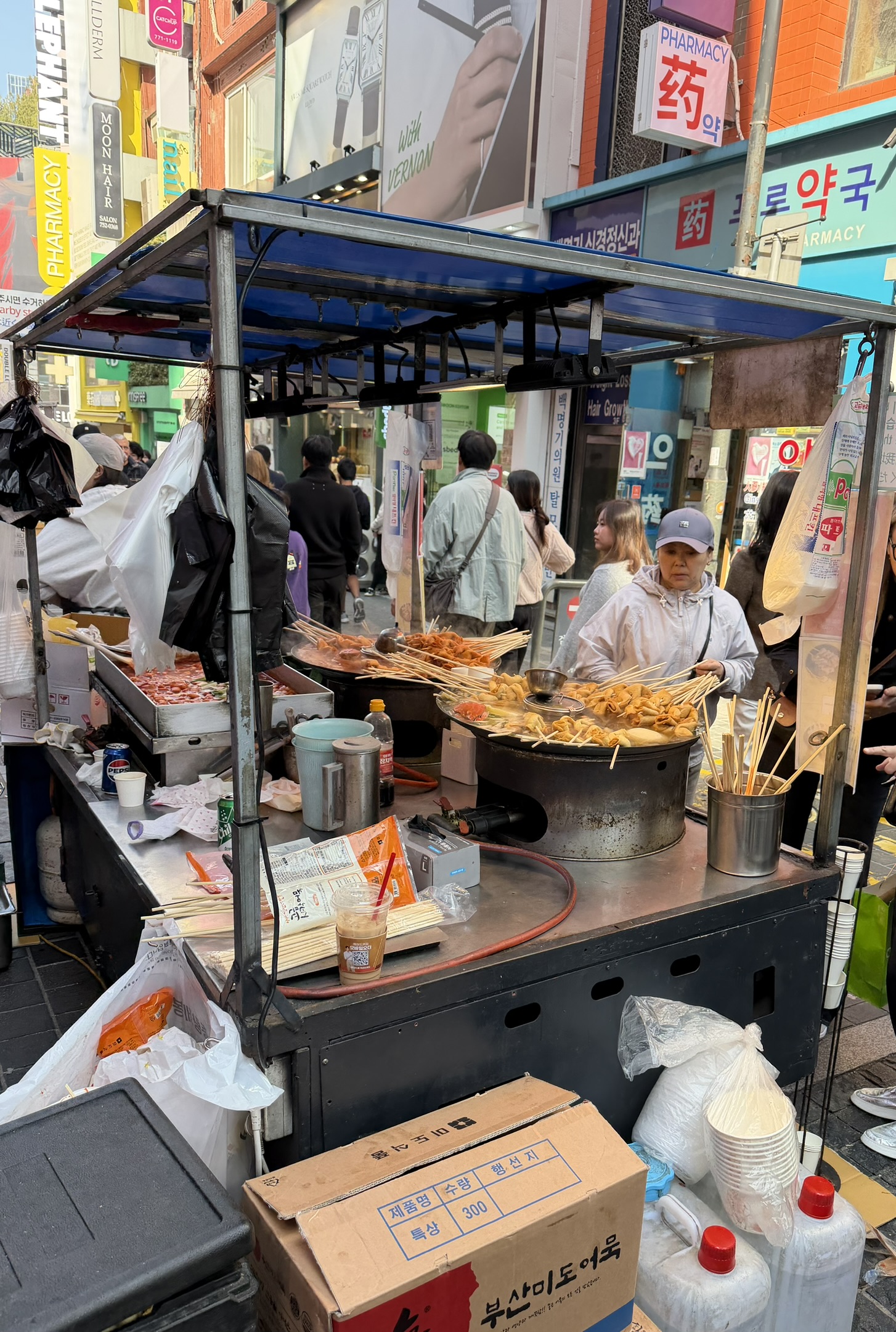 Street food stall in Myeongdong with skewers and tteokbokki 1
