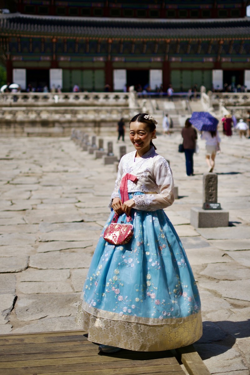 Woman wearing traditional Korean hanbok dress at Gyeongbokgung Palace